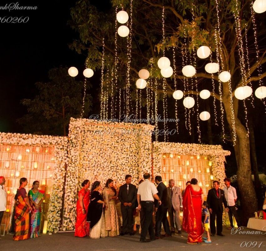 Sheela and Sharans' elegant outdoor wedding reception with floral decor, warm lighting and stunning ambience by Poonam Mayank Sharma, leading wedding planner in Bangalore.