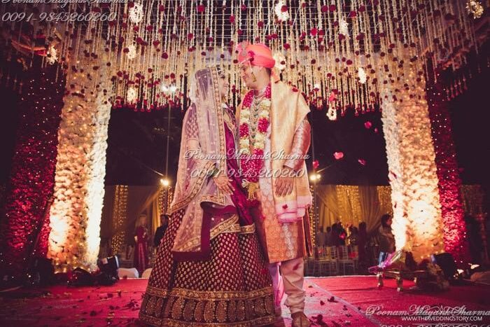 Grand Indian wedding mandap décor with floral ceiling and romantic lighting, designed by Poonam Mayank Sharma, Bangalore’s top wedding planner.